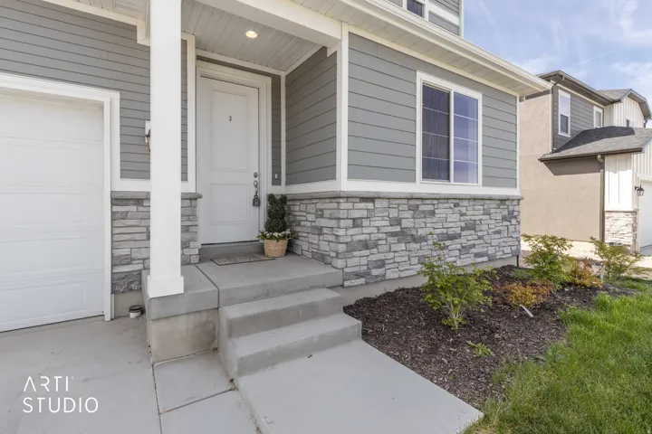 Doorway to property with stone siding