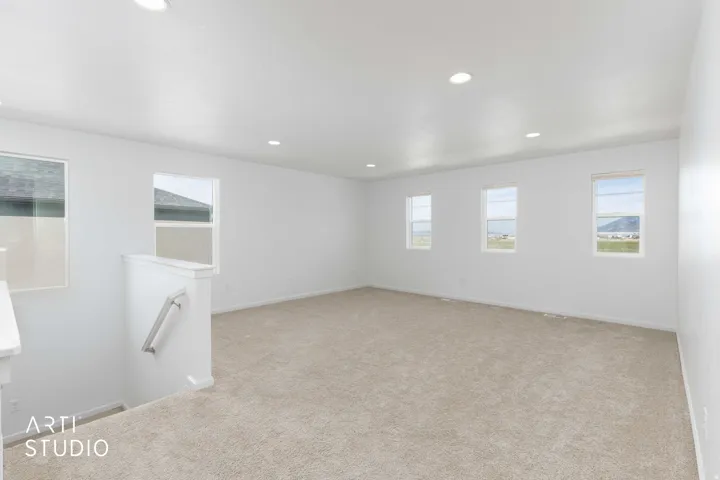 Unfurnished room with recessed lighting and light carpet