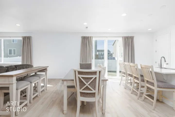 Dining space featuring light wood finished floors and recessed lighting