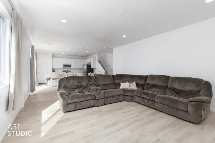 Living area with recessed lighting and light wood-style floors