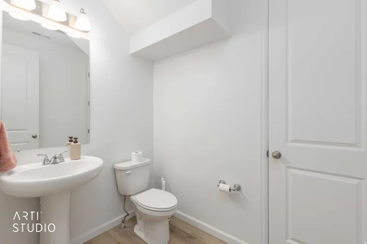 Bathroom featuring toilet and light wood-style floors
