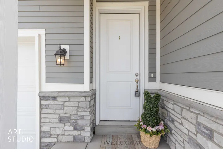 View of exterior entry with stone siding