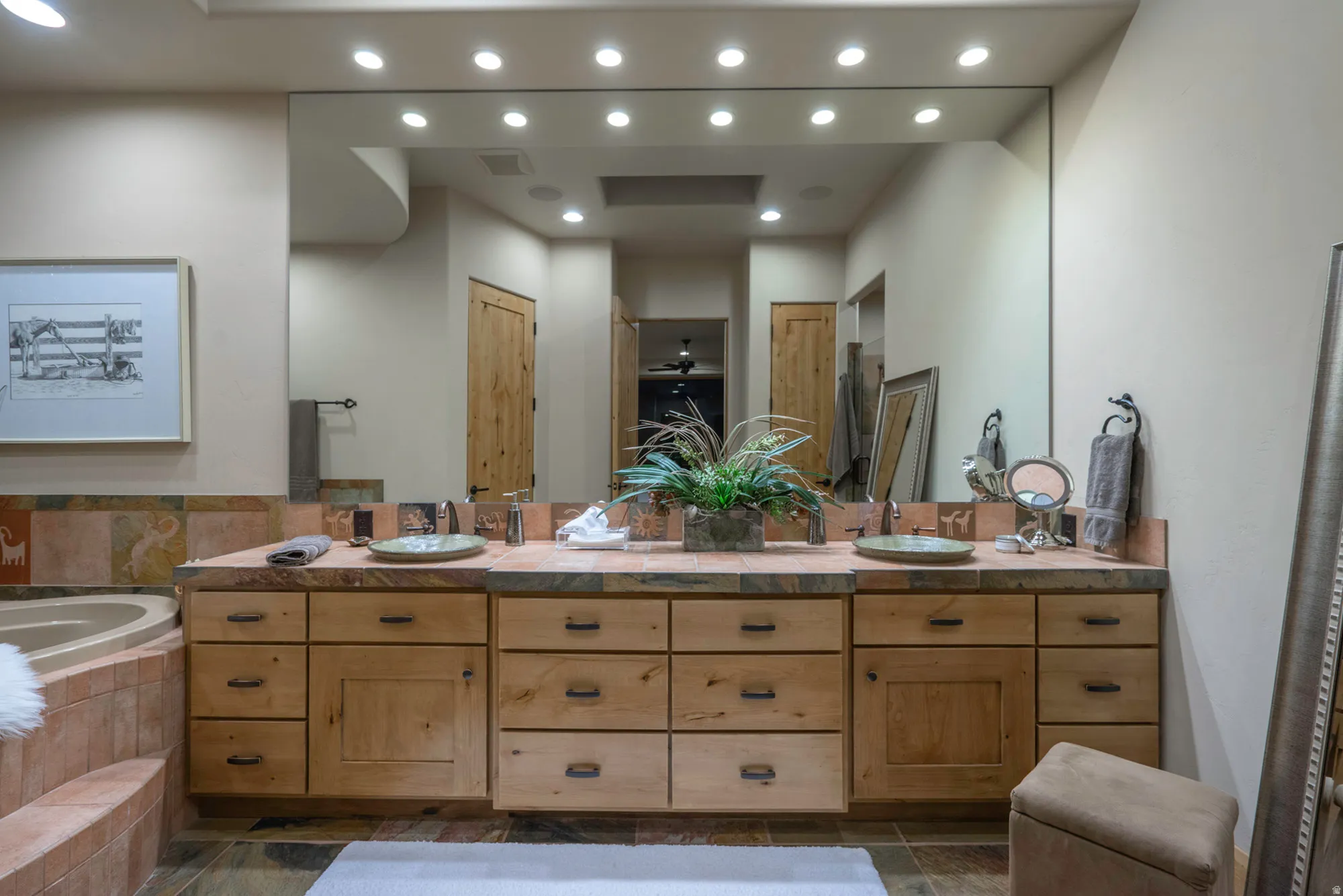 Full bath featuring double vanity, a bath, and recessed lighting