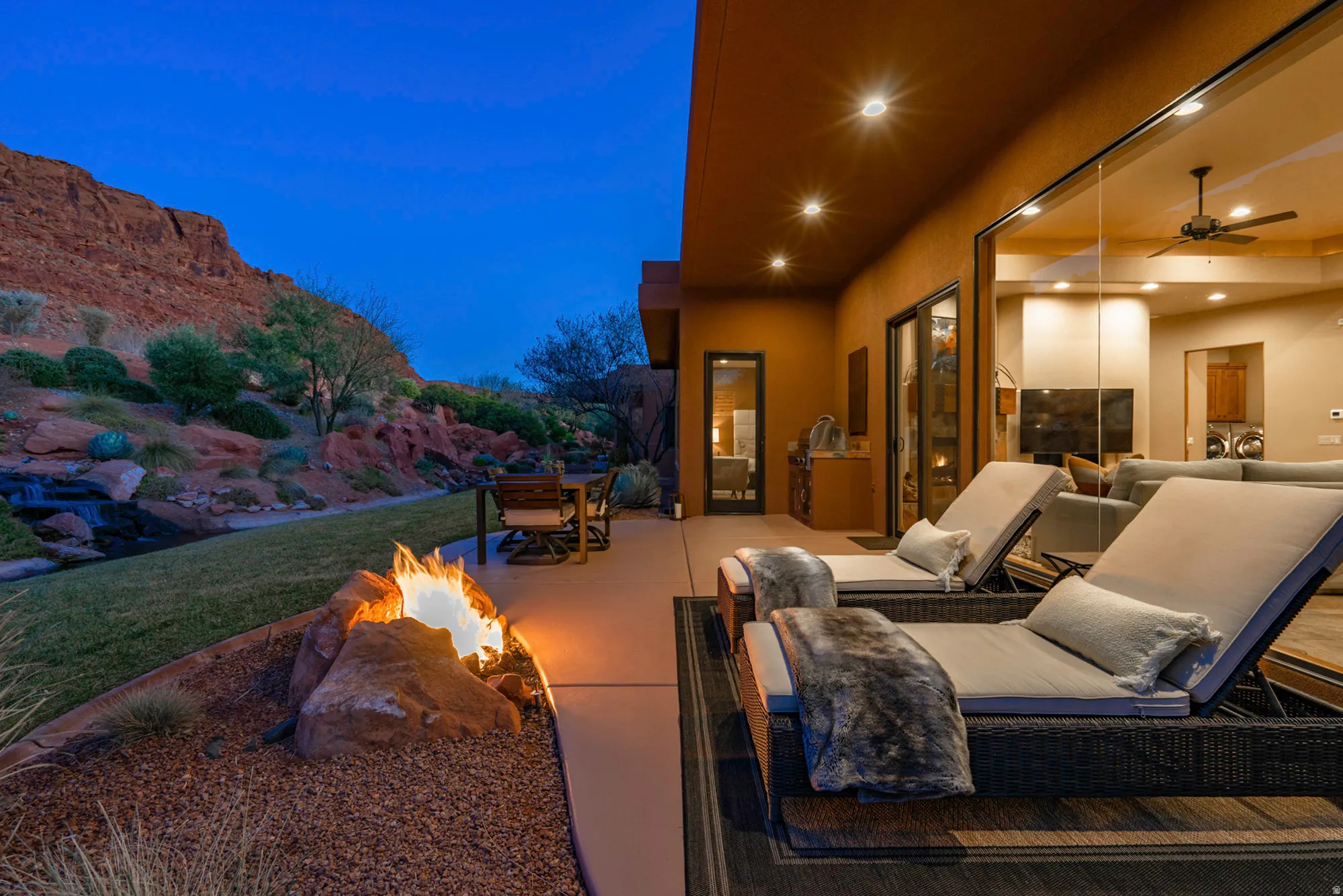 View of patio / terrace with a fire pit, outdoor dining area, and ceiling fan