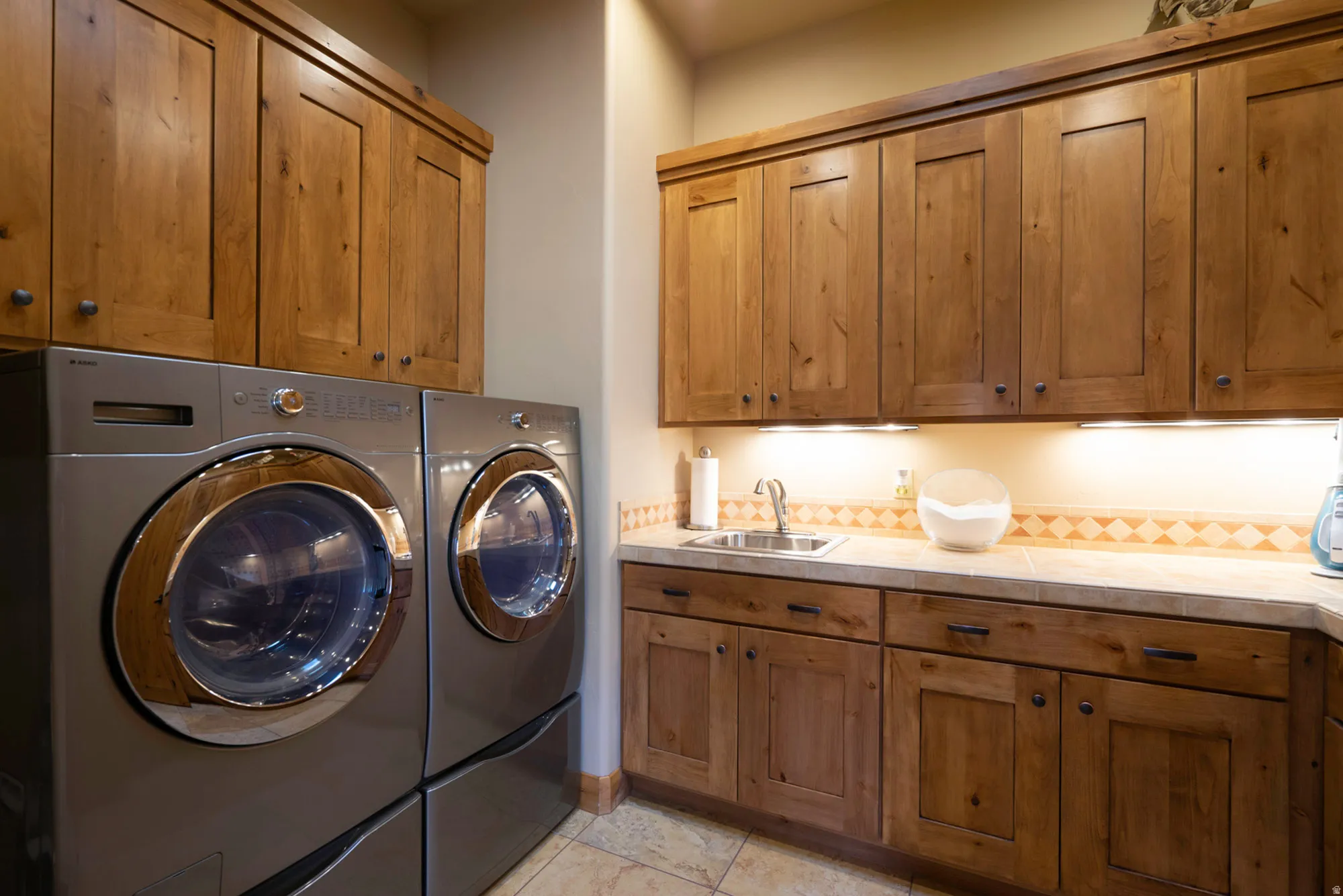 Laundry room with independent washer and dryer and cabinet space
