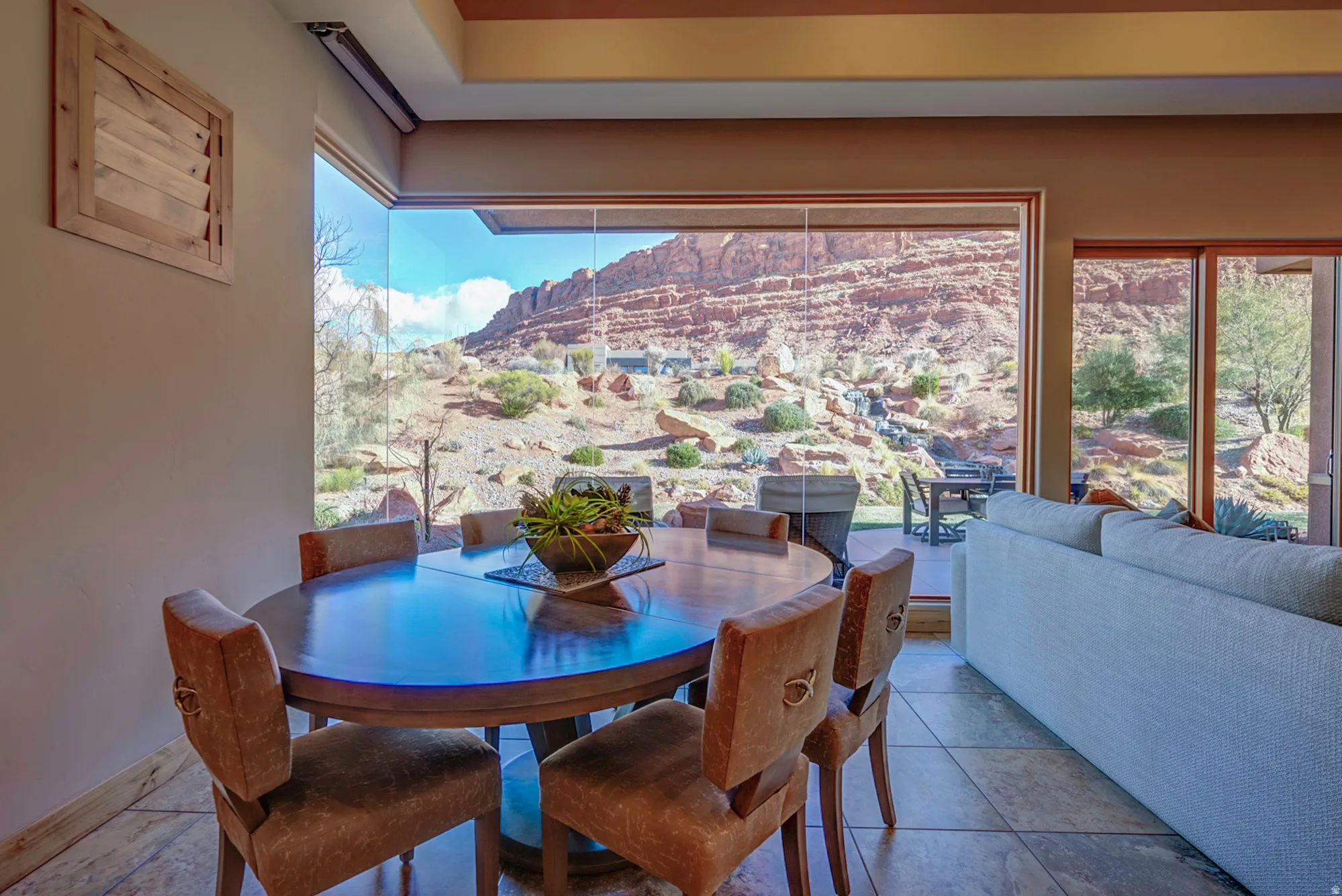 Dining area featuring healthy amount of natural light, stone tile flooring, and a mountain view