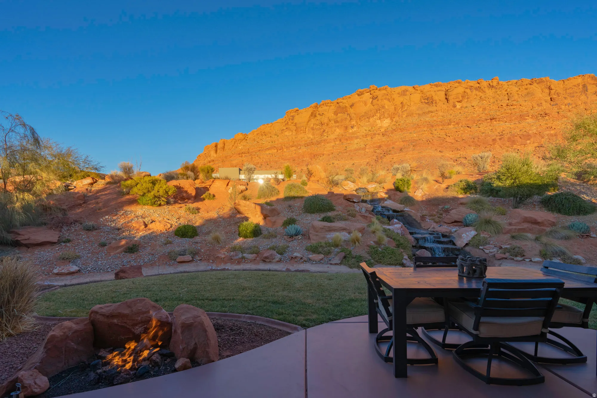View of patio with outdoor dining area, an outdoor fire pit, and a mountain view