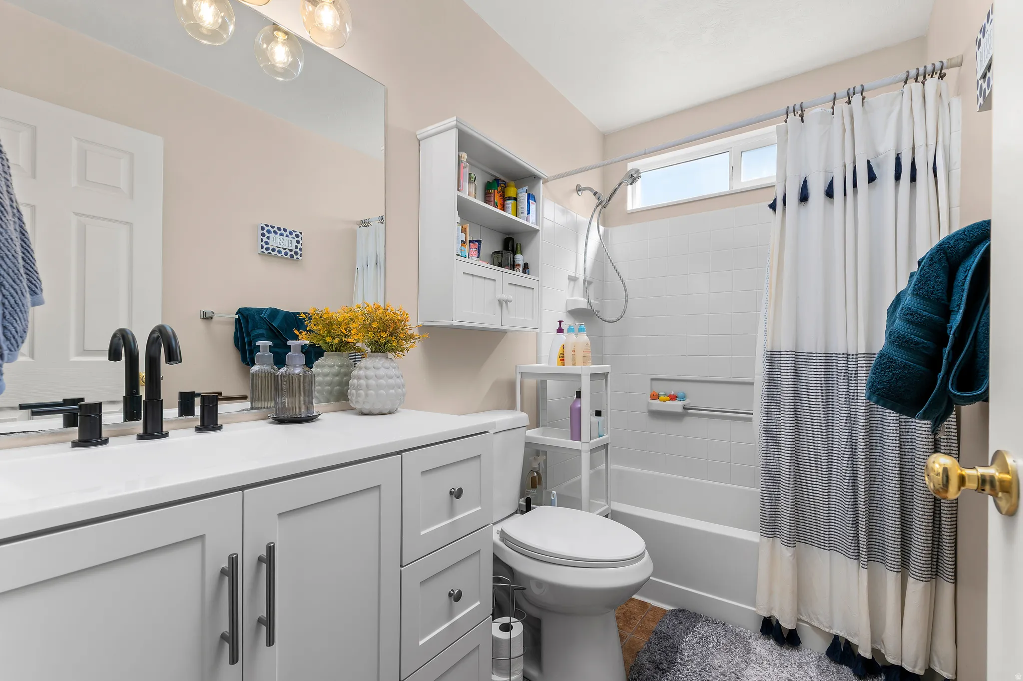 Full bath featuring vanity and shower / bath combo with shower curtain