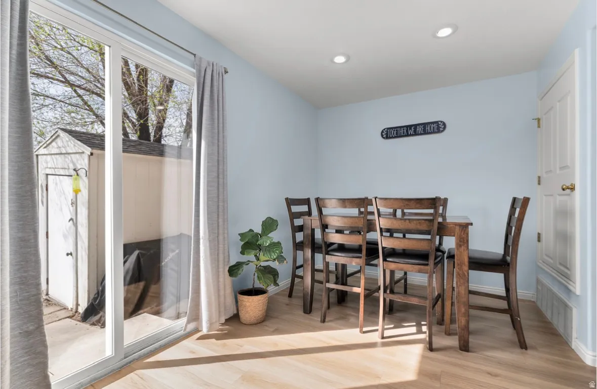 Dining space featuring light wood finished floors and recessed lighting