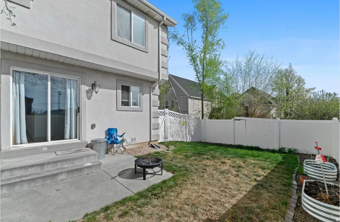 Fenced backyard with a patio, a fire pit, and entry steps