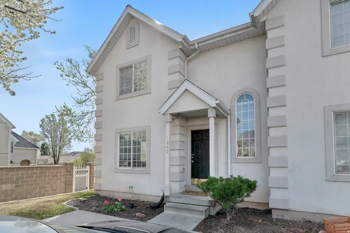 View of front facade featuring stucco siding