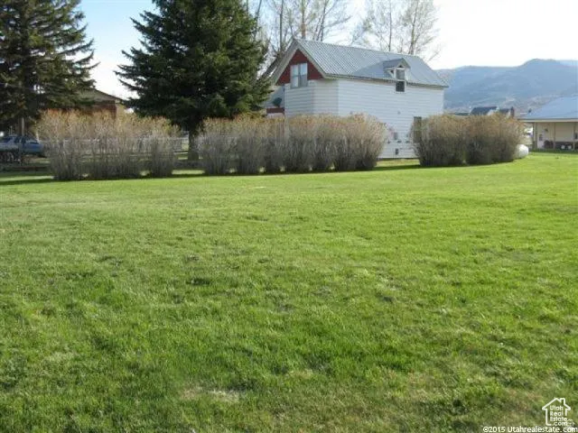 View of grassy yard featuring a mountain view