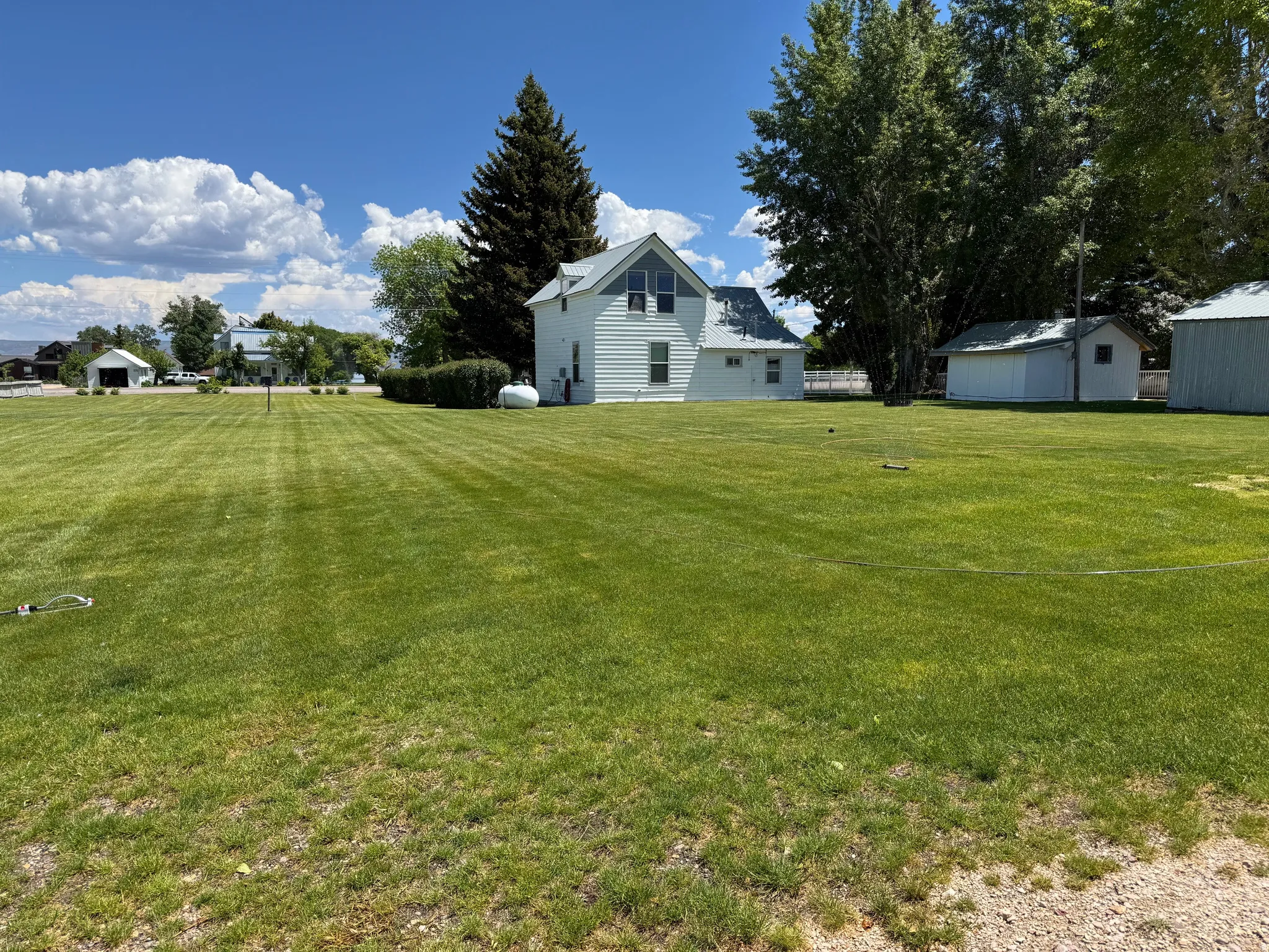 Yard with RV-hookup at rear of home