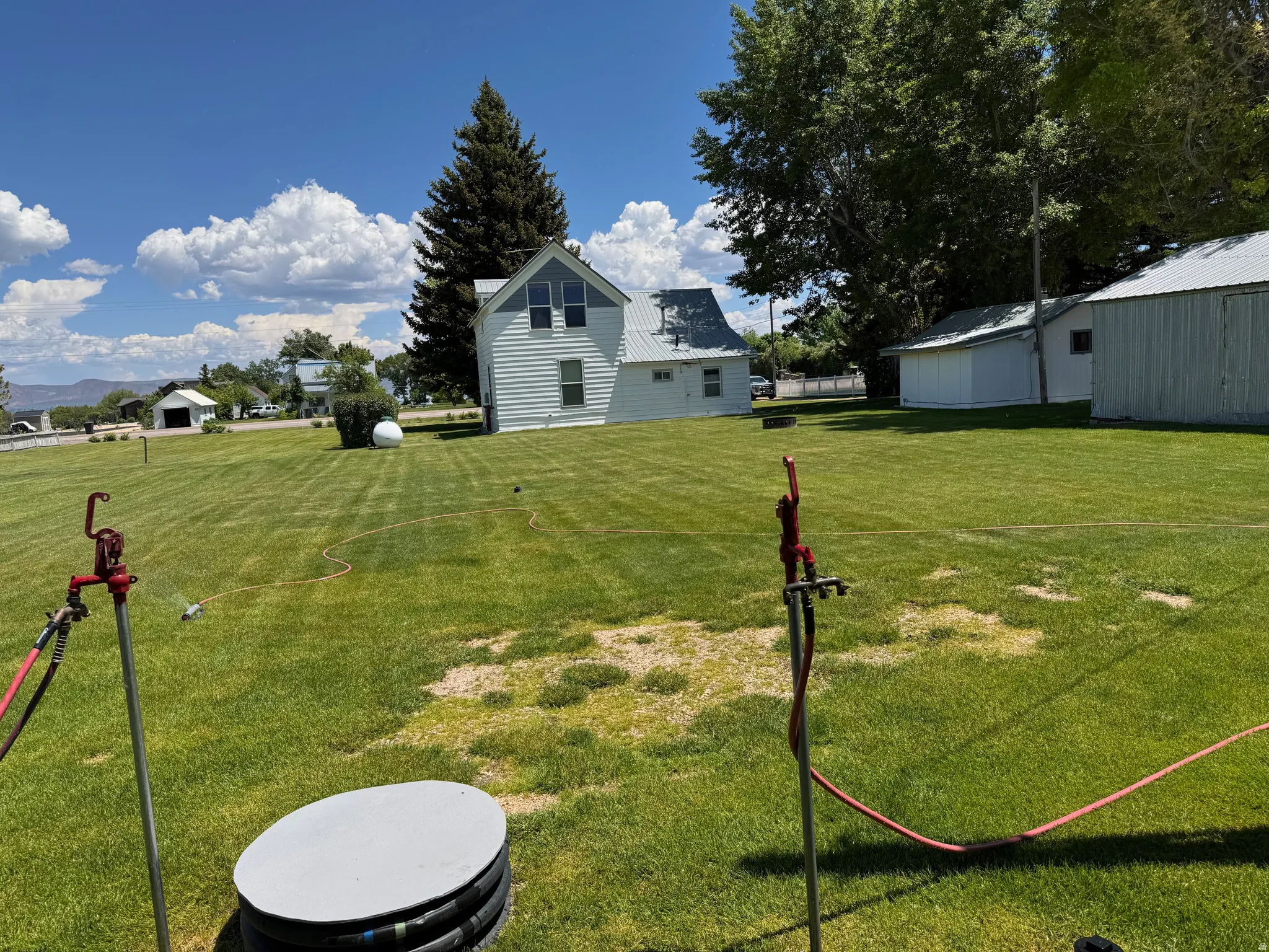 Yard with RV-hookup at rear of home