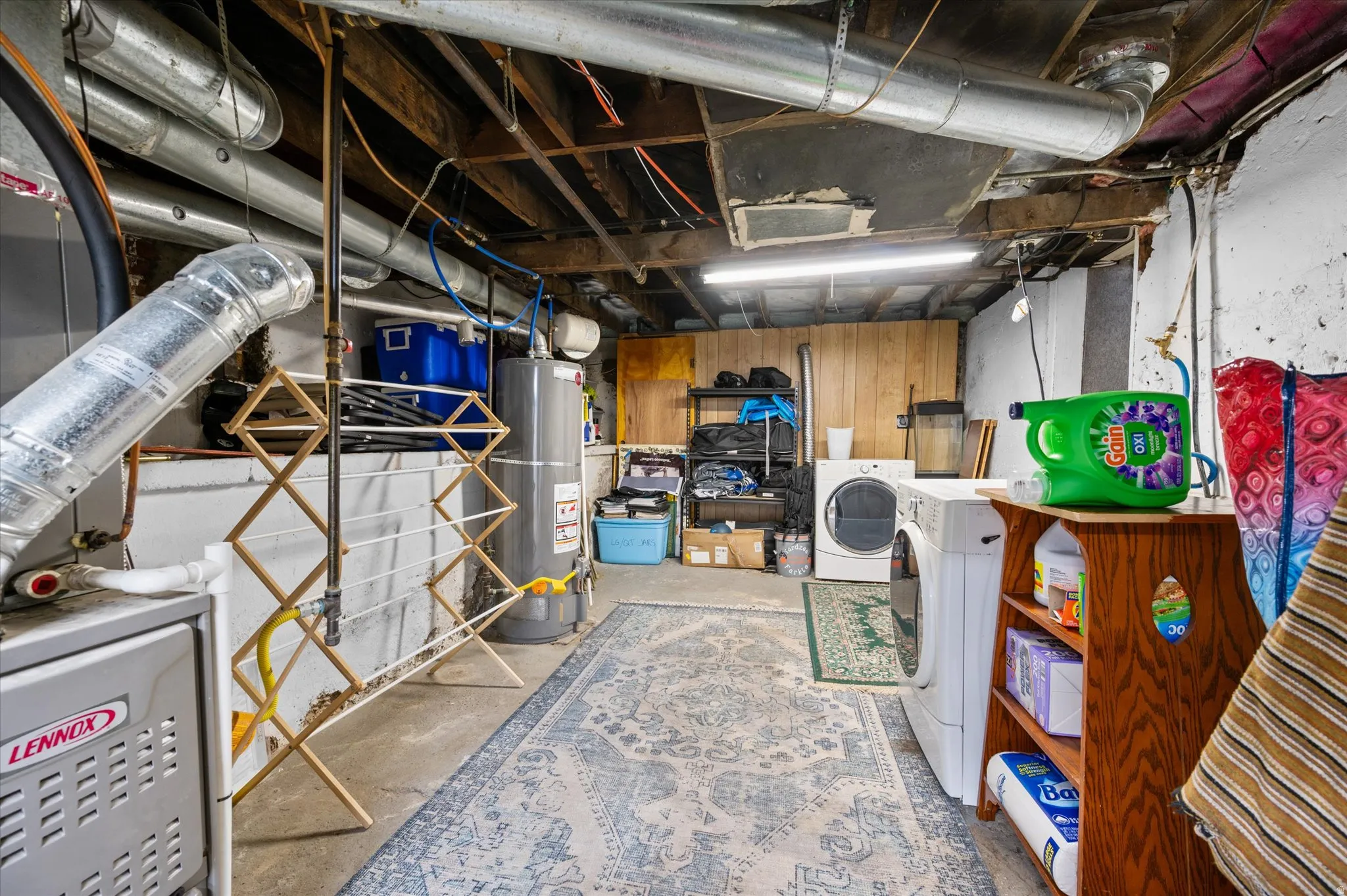 Unfinished basement featuring water heater and heating unit