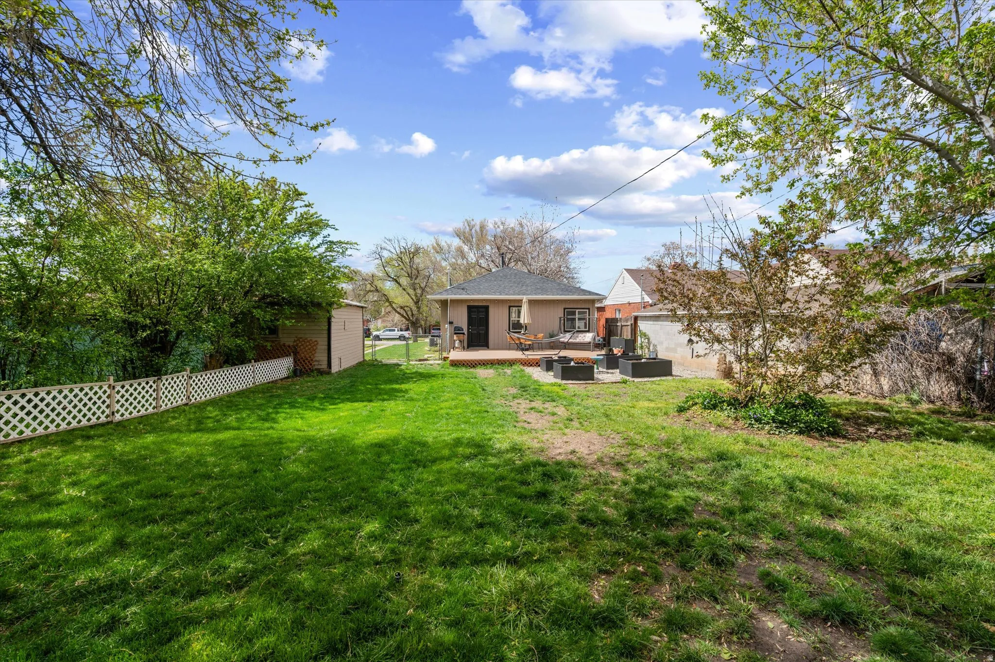 Rear view of property with a fenced backyard, a patio area, and an outdoor living space
