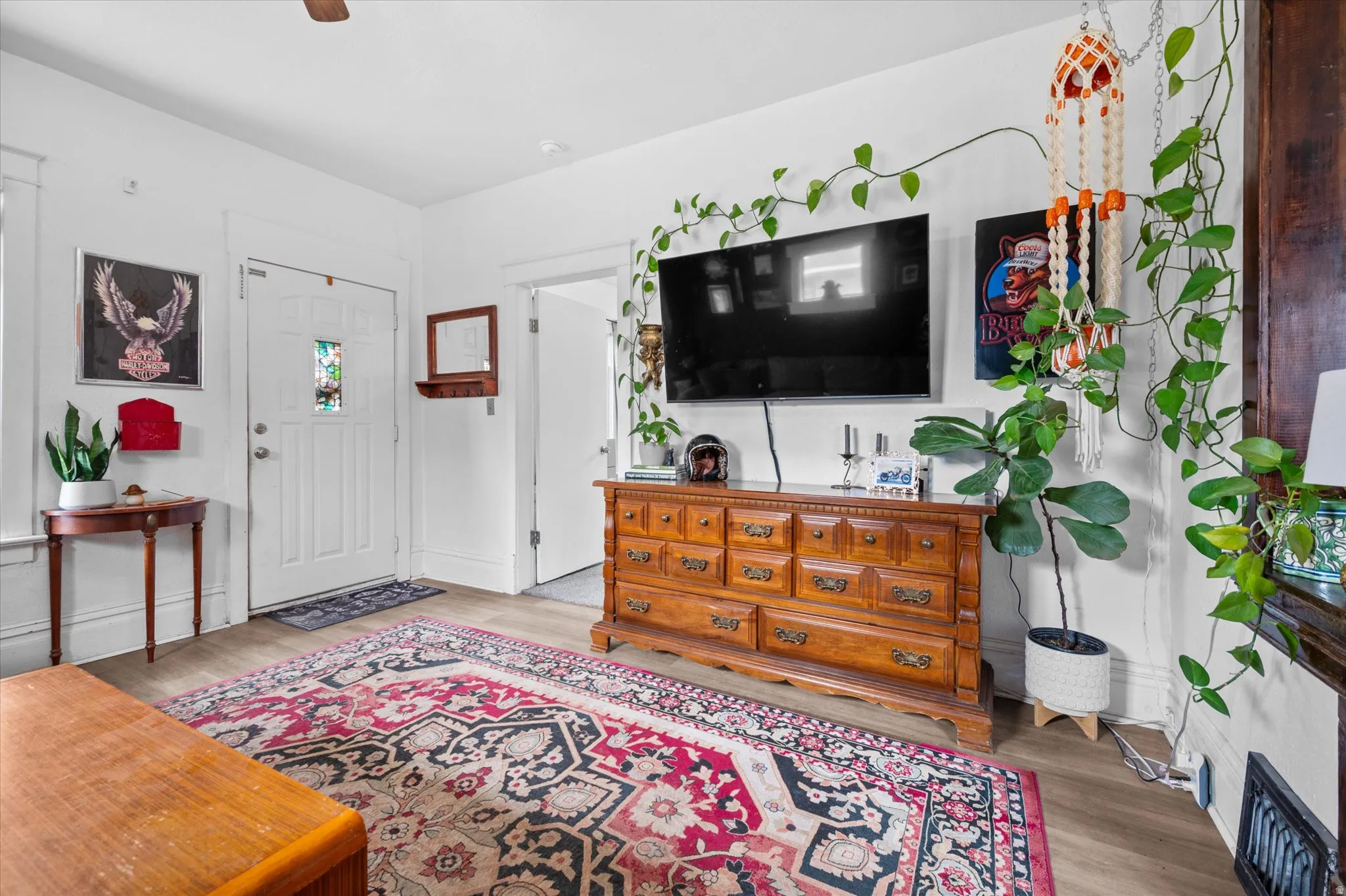 Entrance foyer with light wood-style flooring and a ceiling fan
