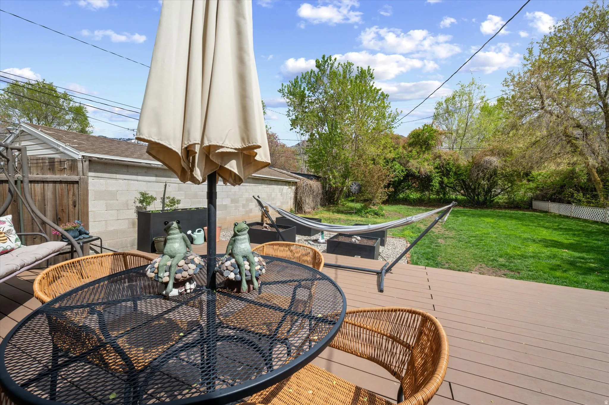 Wooden terrace featuring a fenced backyard and outdoor dining space