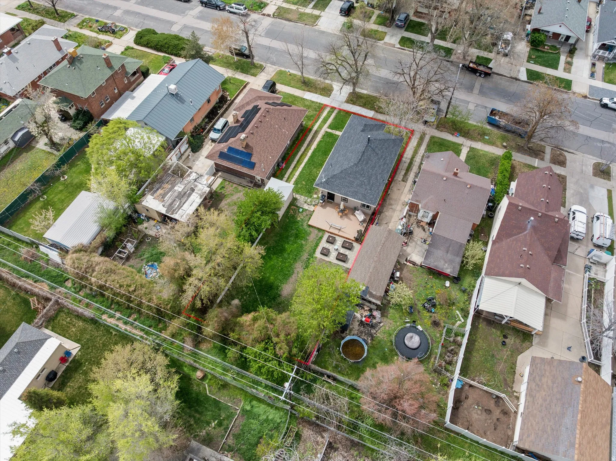 Aerial perspective of suburban area featuring property boundaries highlighted