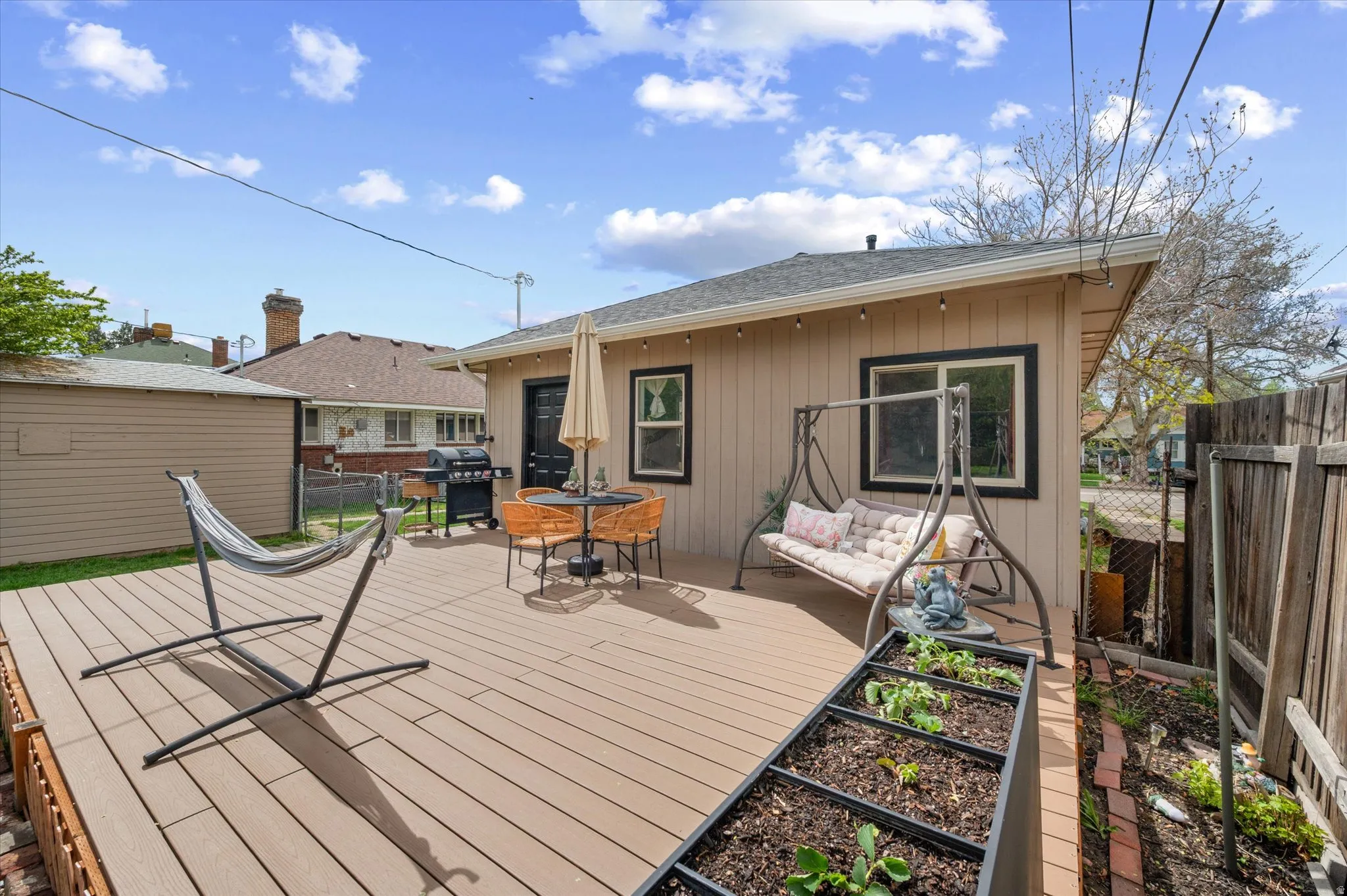 Wooden deck featuring grilling area and outdoor furniture