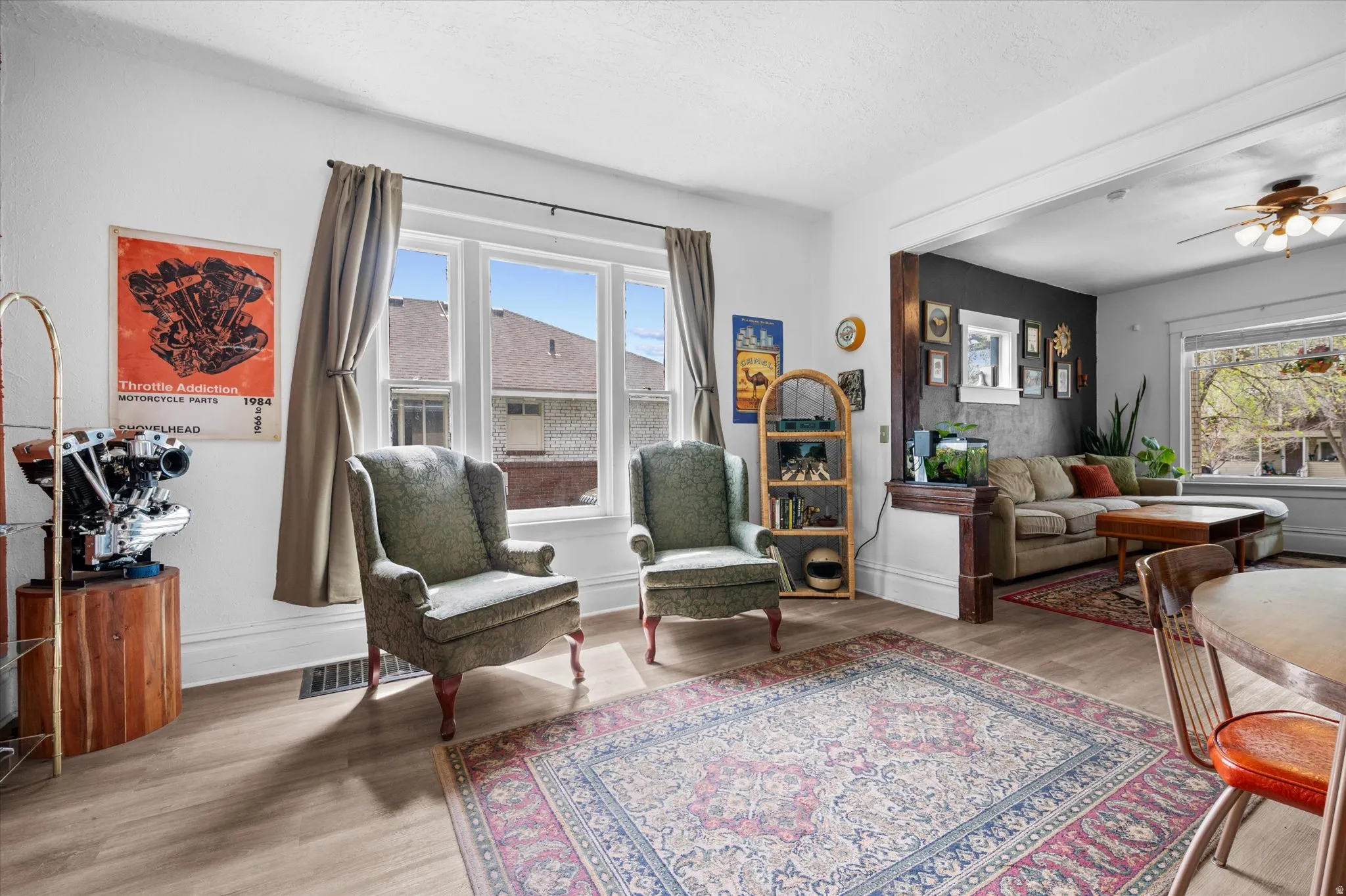 Living area with a ceiling fan and light wood finished floors