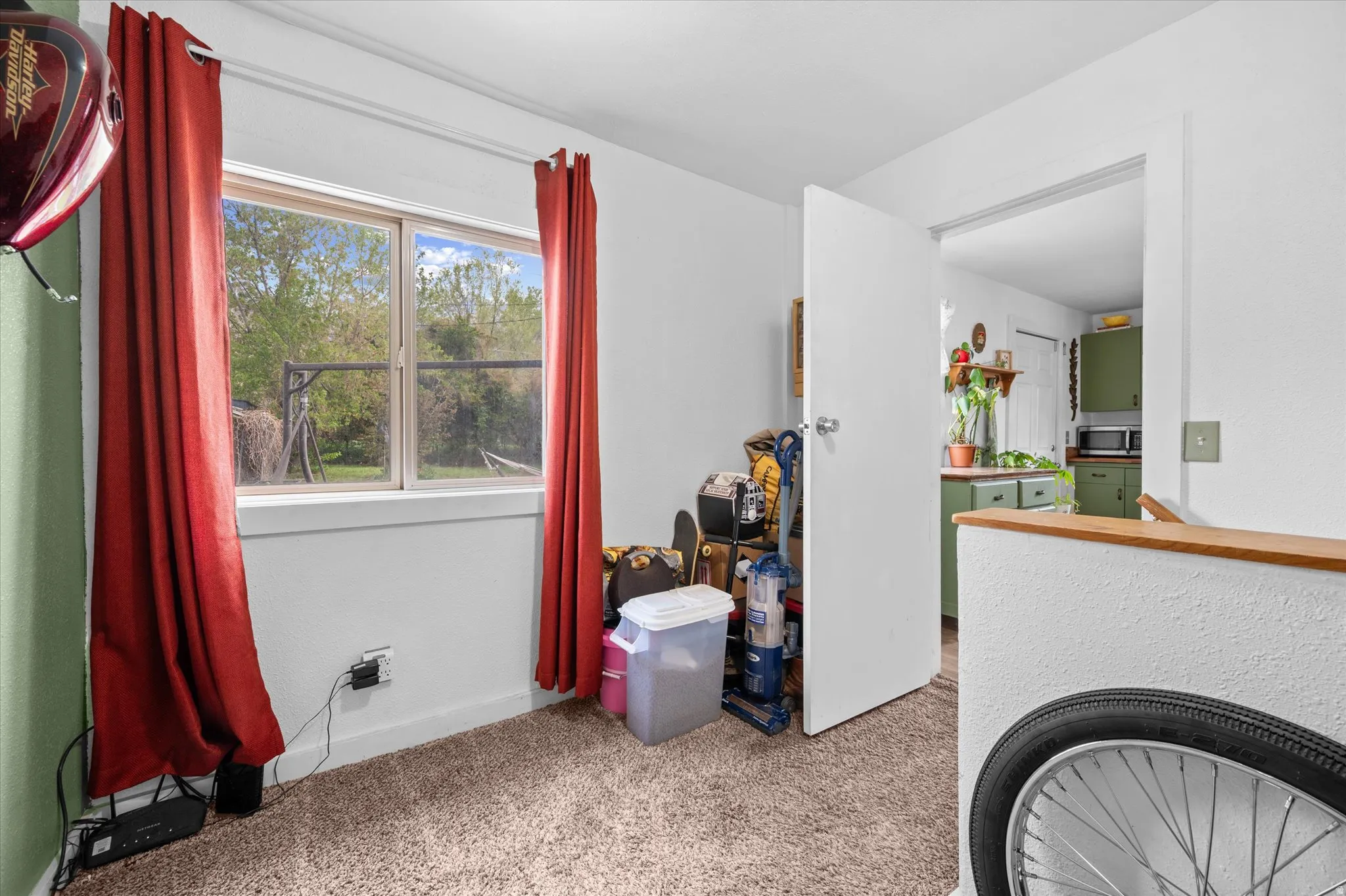 Living area with baseboards and light carpet