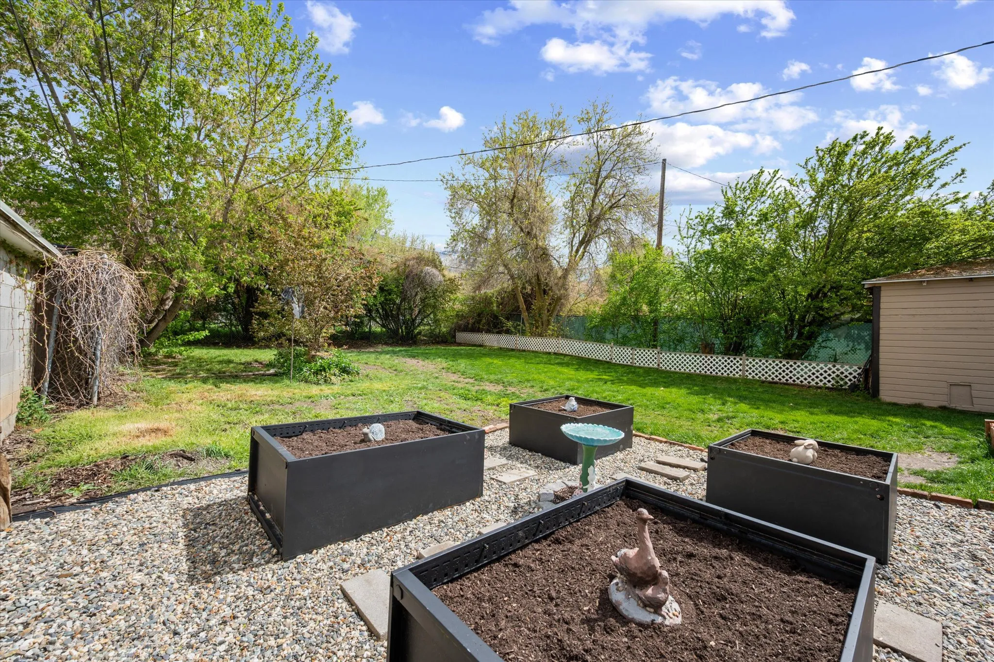 Fenced backyard featuring a garden and a patio