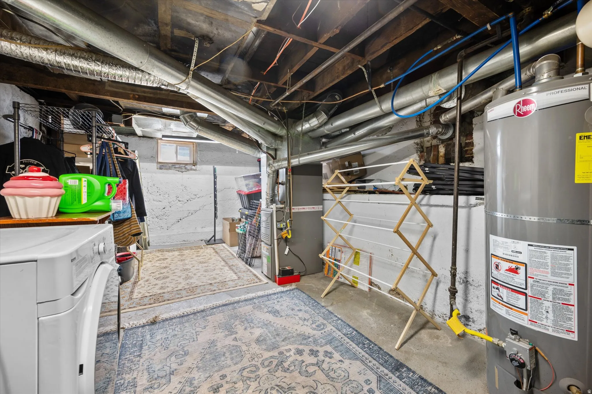 Basement with water heater, heating unit, and separate washer and dryer