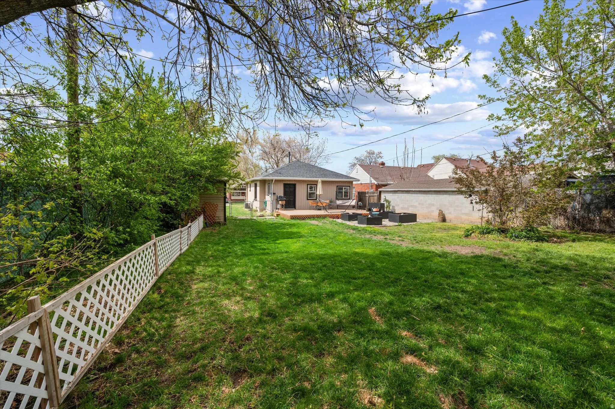 Back of property featuring a fenced backyard, a patio, and an outdoor lounge area