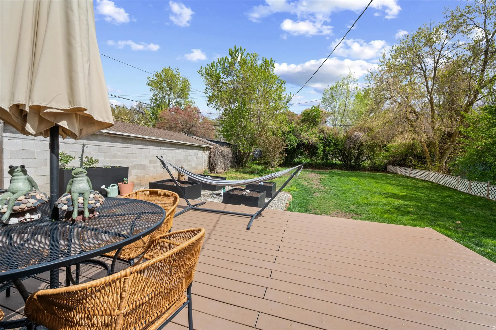 Wooden deck with a fenced backyard and outdoor dining area