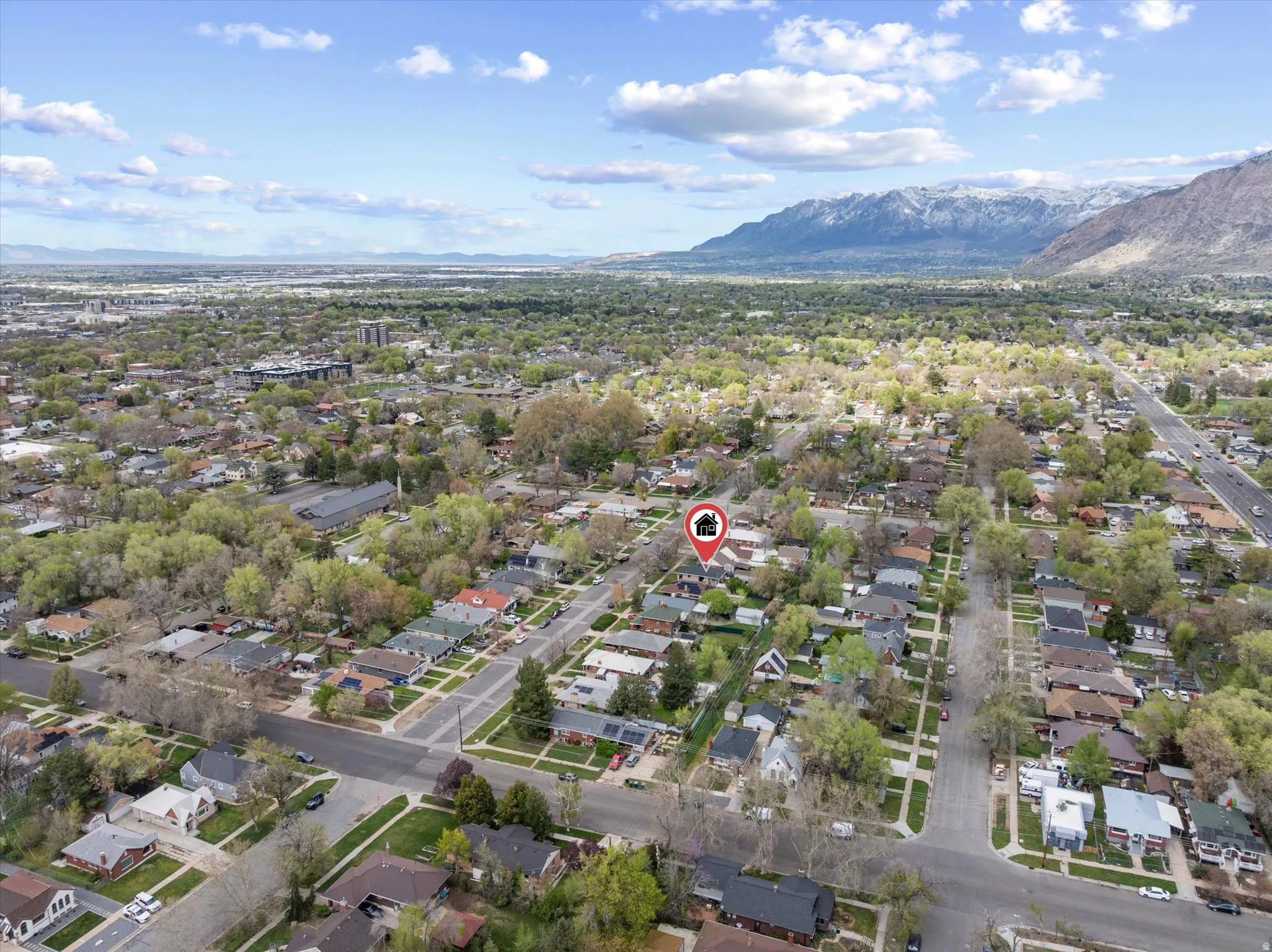 Aerial view of property's location with mountains and nearby suburban area