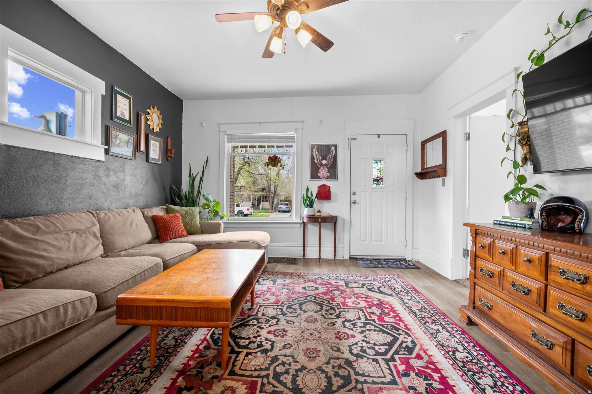 Living area featuring ceiling fan and light wood-type flooring