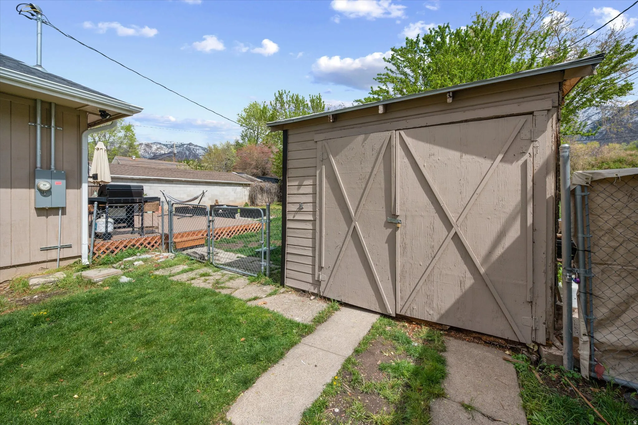 View of shed featuring a gate