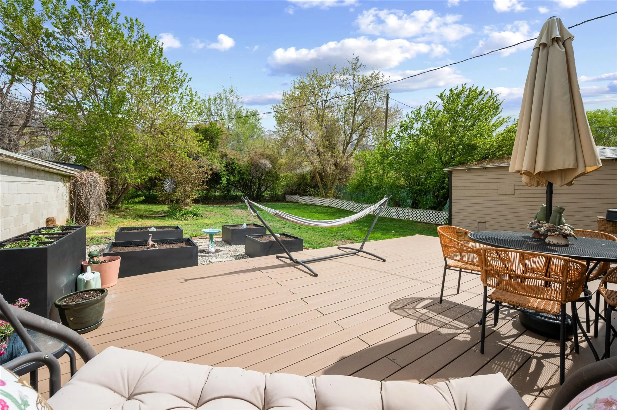Wooden deck featuring outdoor lounge area, a fenced backyard, and a fire pit
