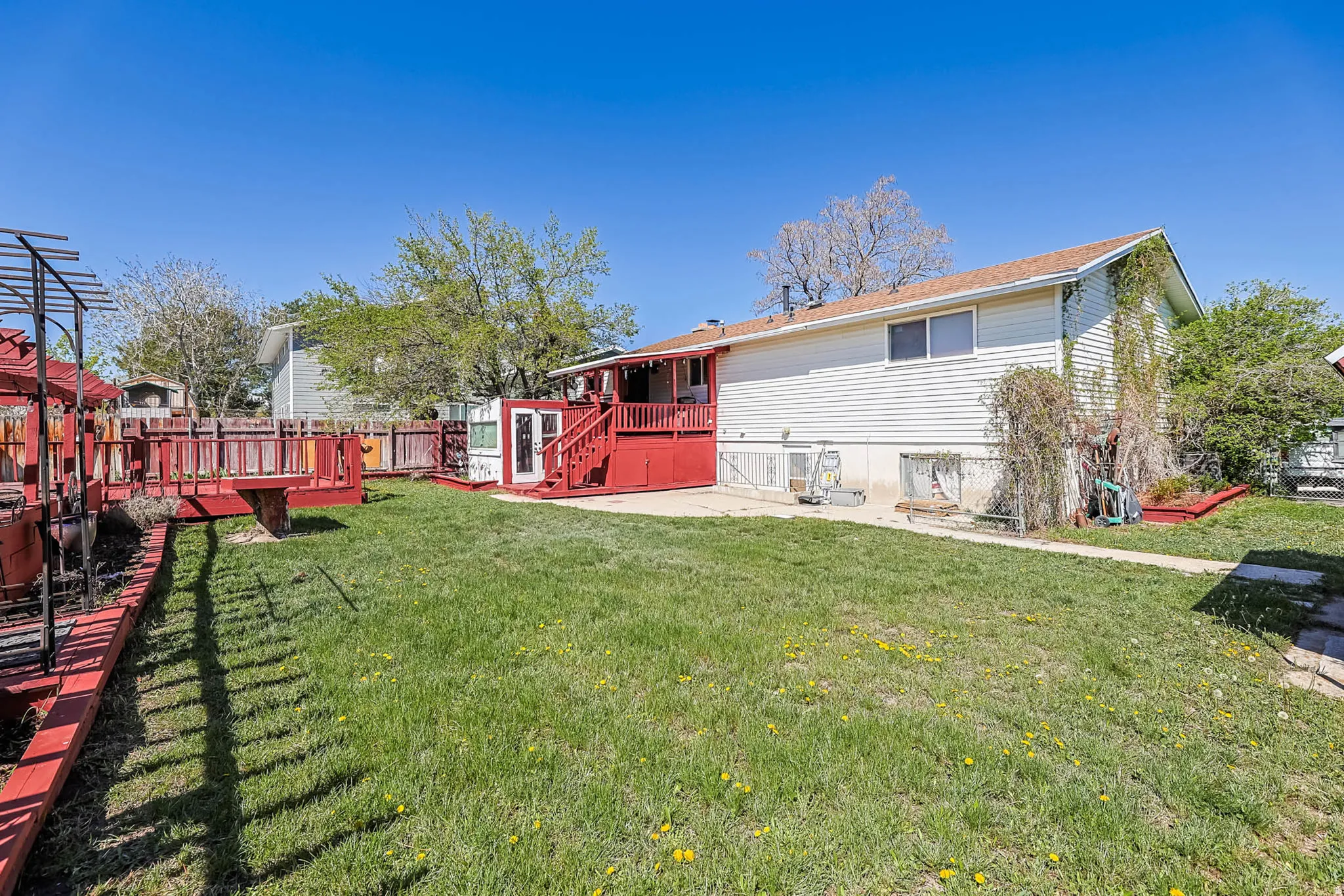 Rear view of house with a patio area, a fenced backyard, and a deck