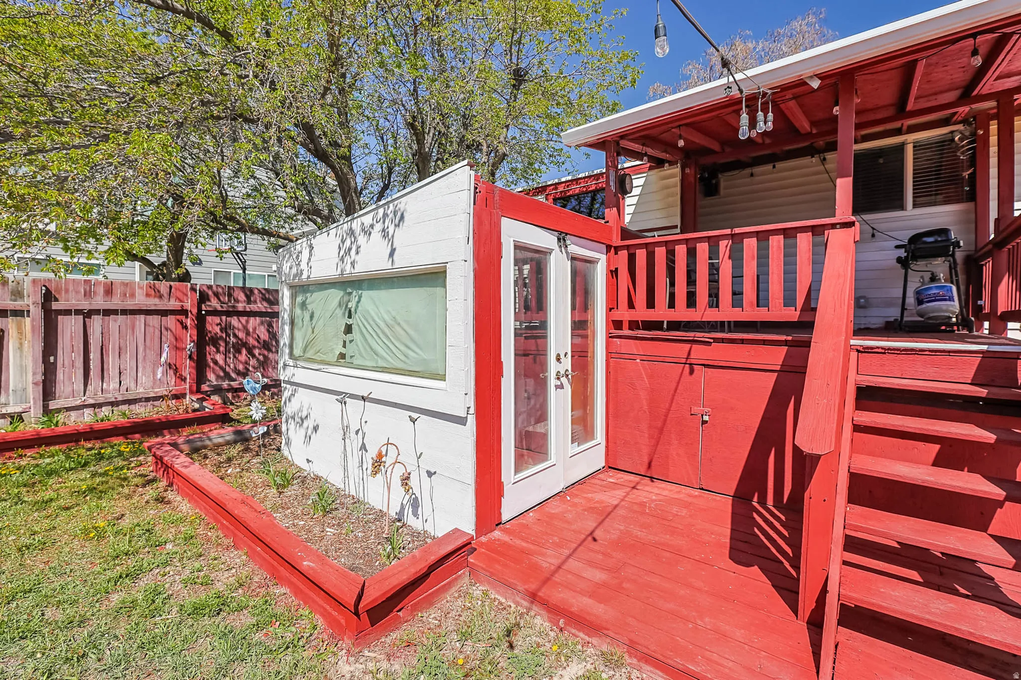 View of home's exterior with an outbuilding and a wooden deck