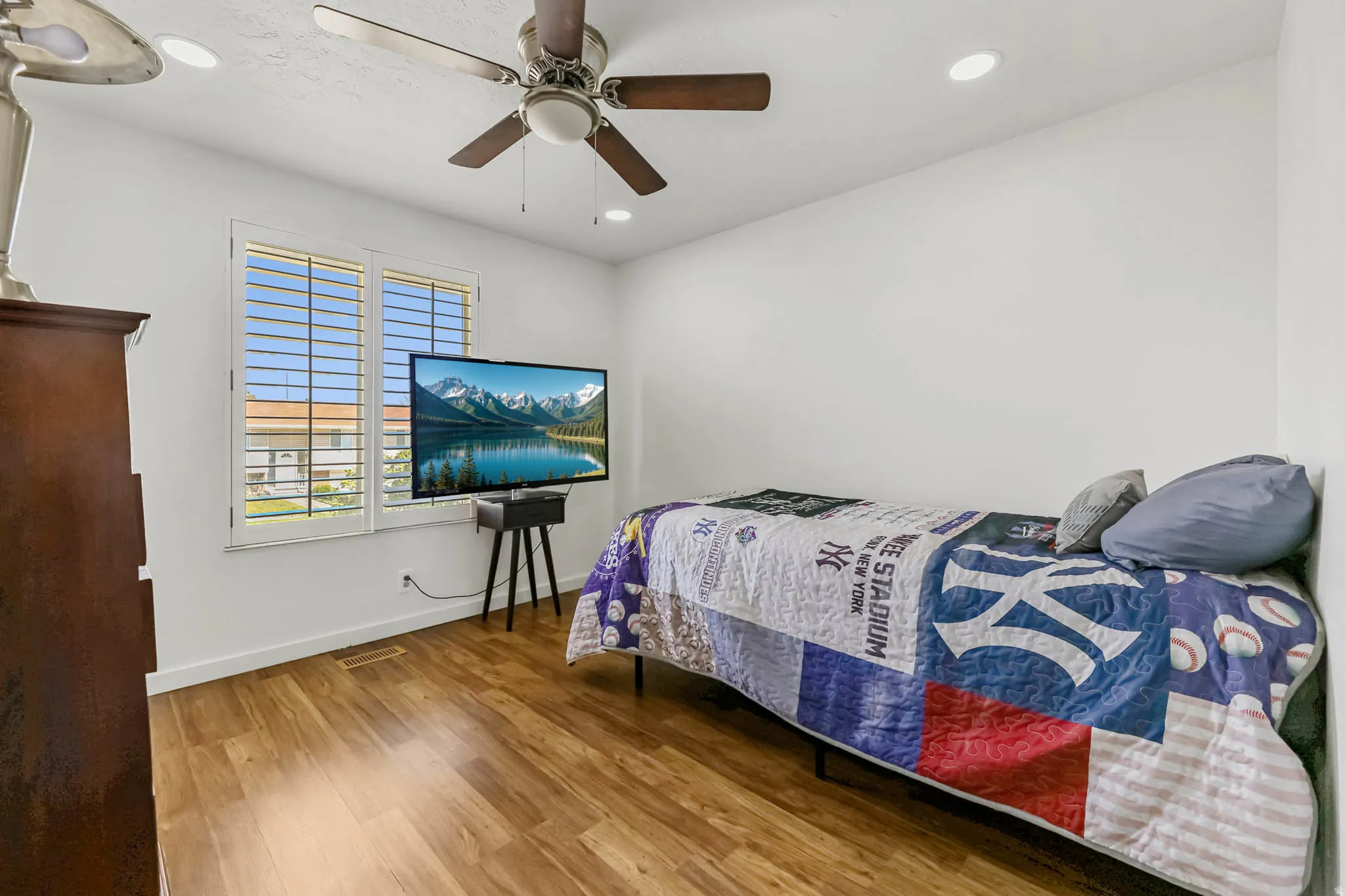 Bedroom featuring light wood finished floors, a ceiling fan, and recessed lighting