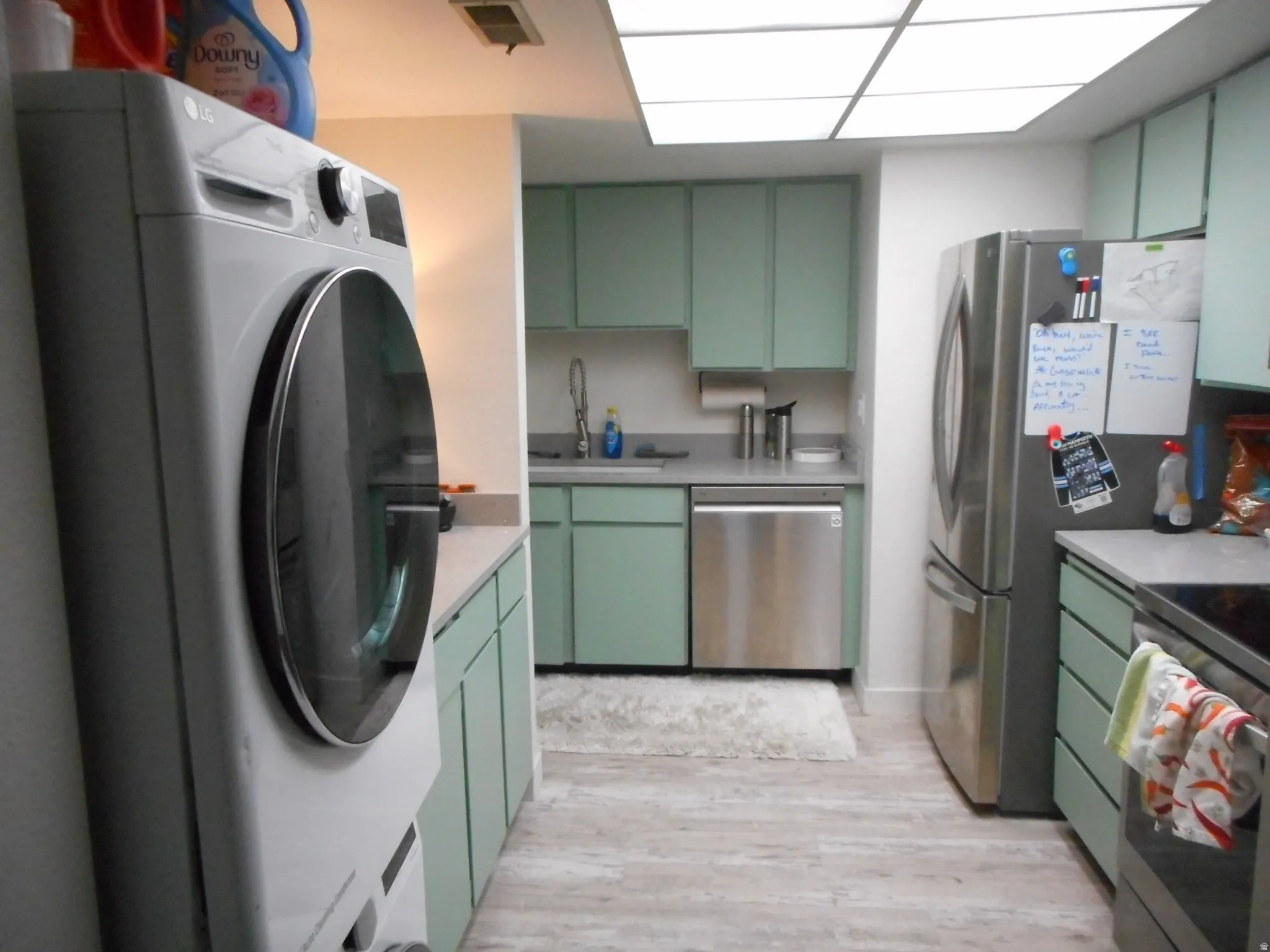 Kitchen featuring green cabinets and washer / clothes dryer