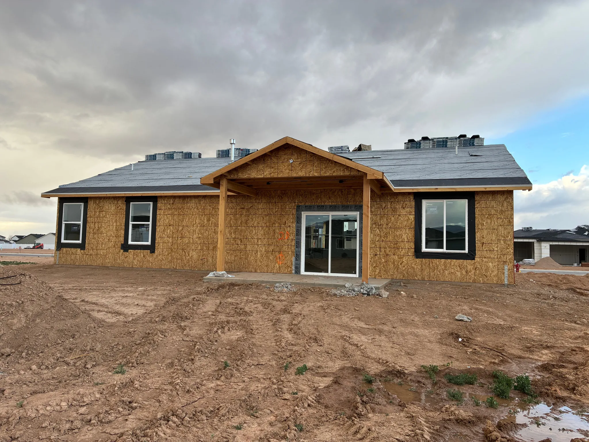 Back of property featuring a covered patio