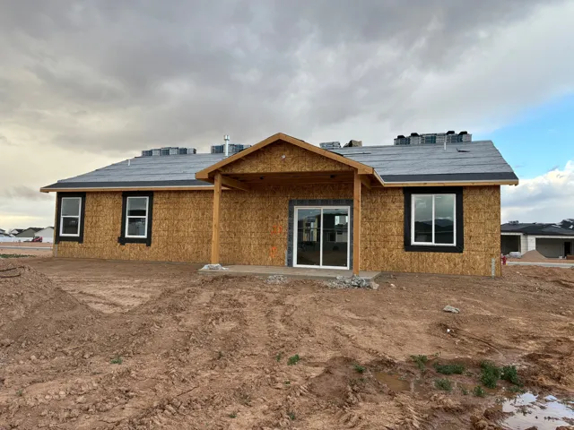 Back of property featuring a covered patio