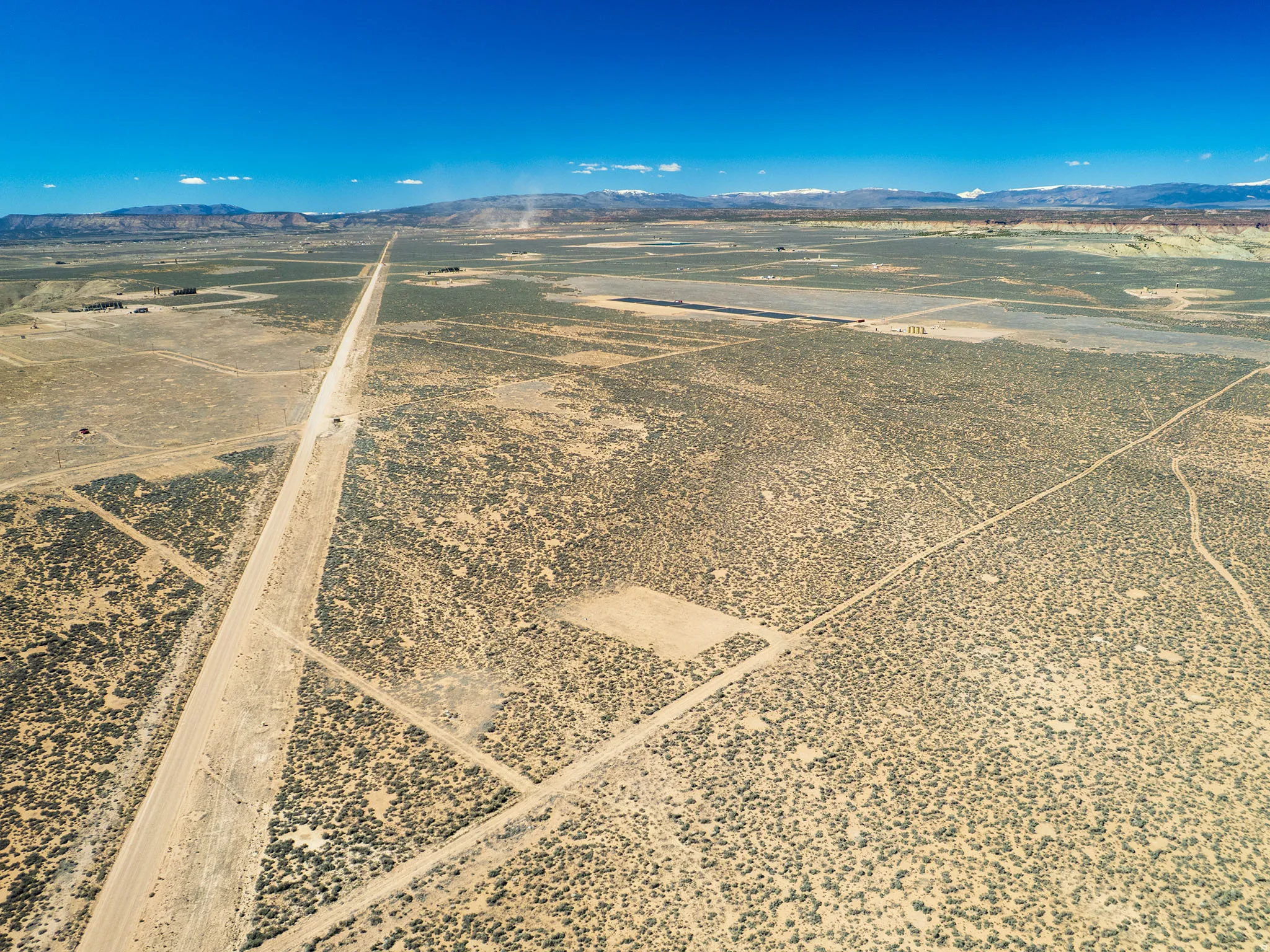 Aerial view of sparsely populated area with a mountainous background and a desert landscape