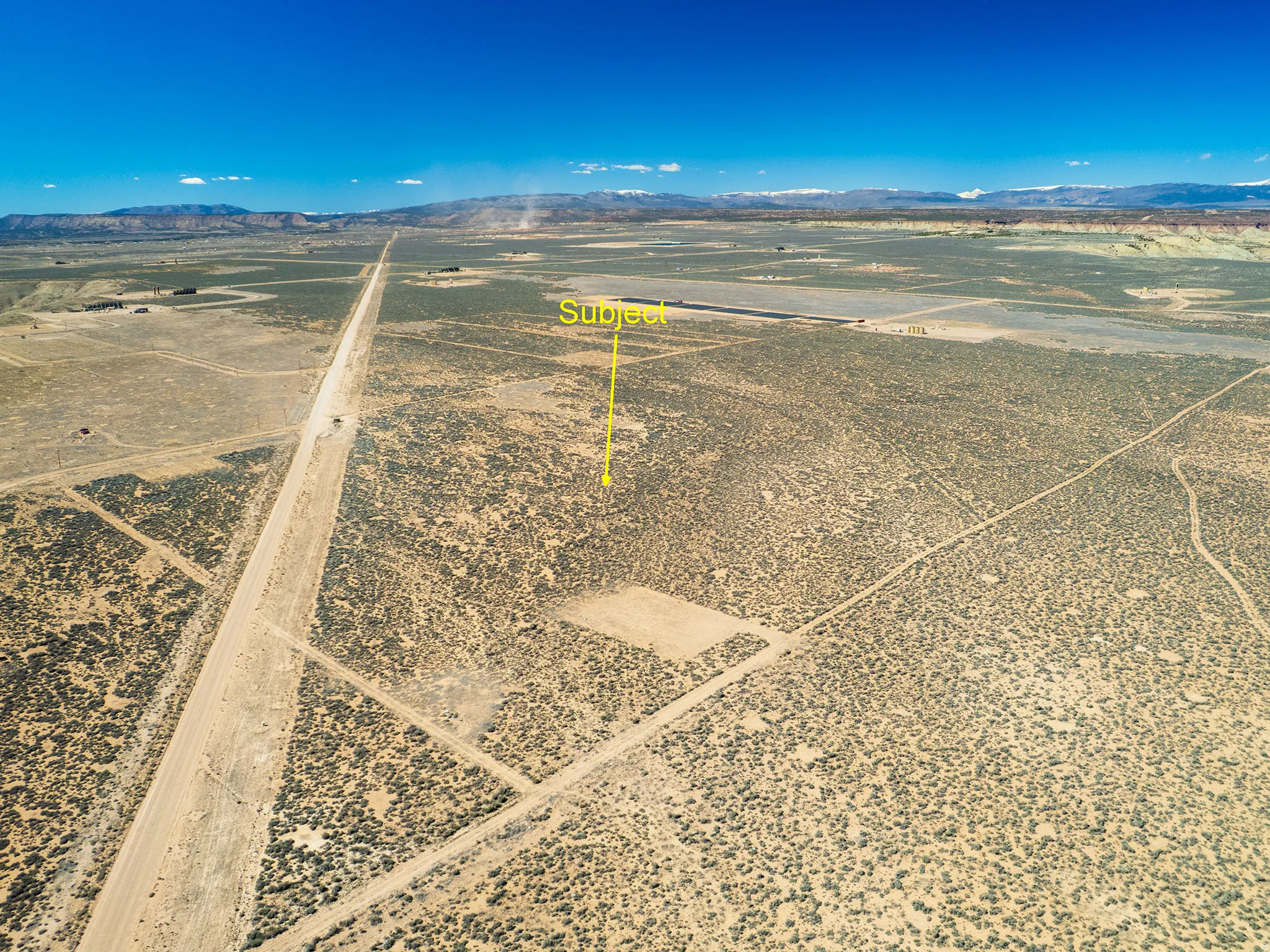 Aerial view of sparsely populated area featuring mountains and a desert landscape