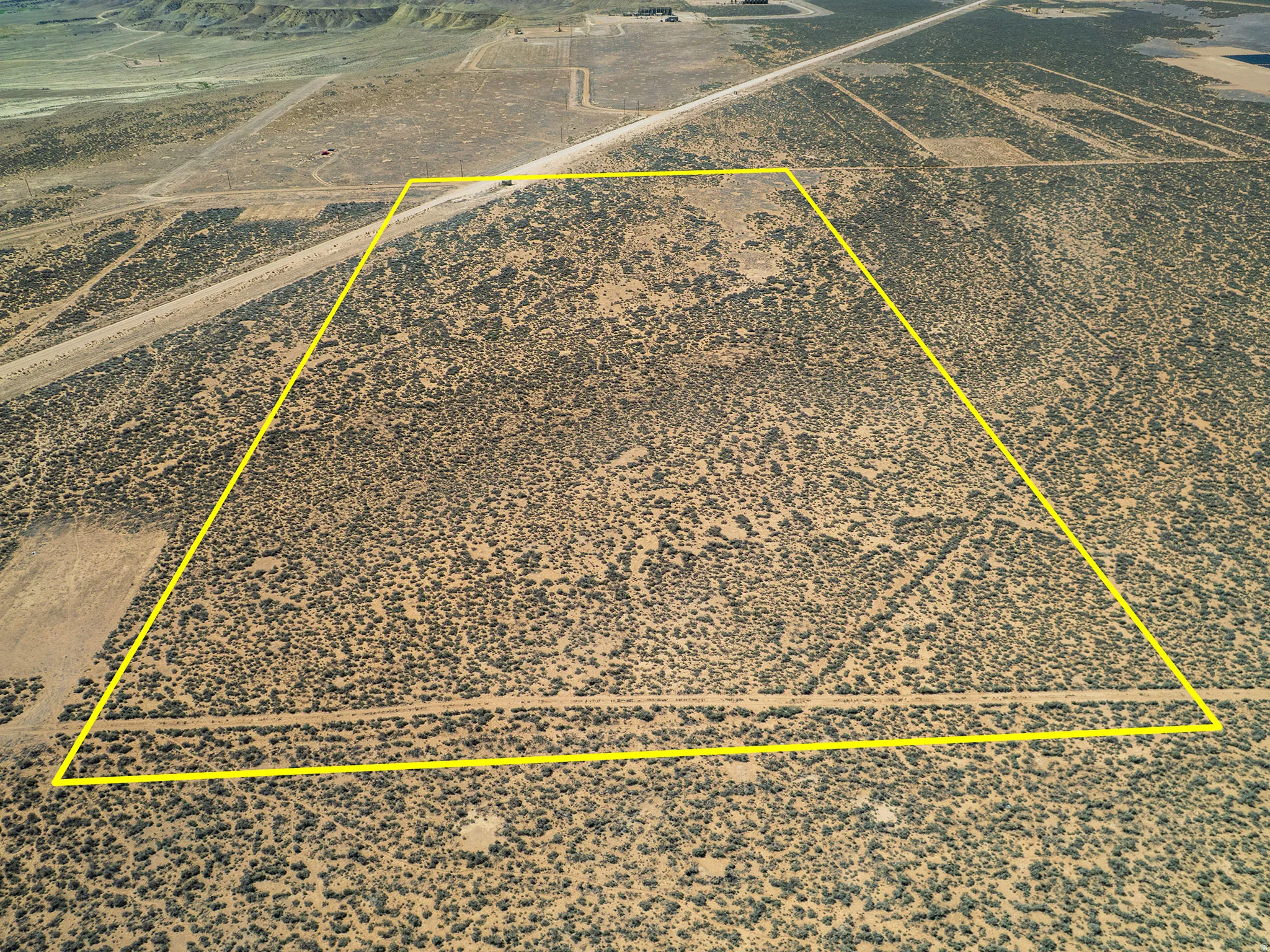 Aerial view of sparsely populated area with a desert landscape and property parcel outlined