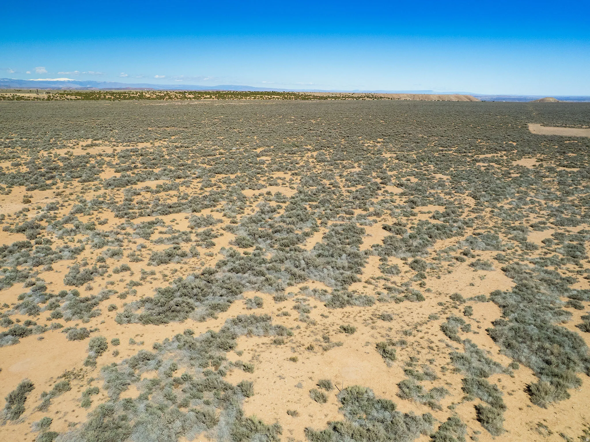 View of rural area featuring a desert landscape and a mountain backdrop
