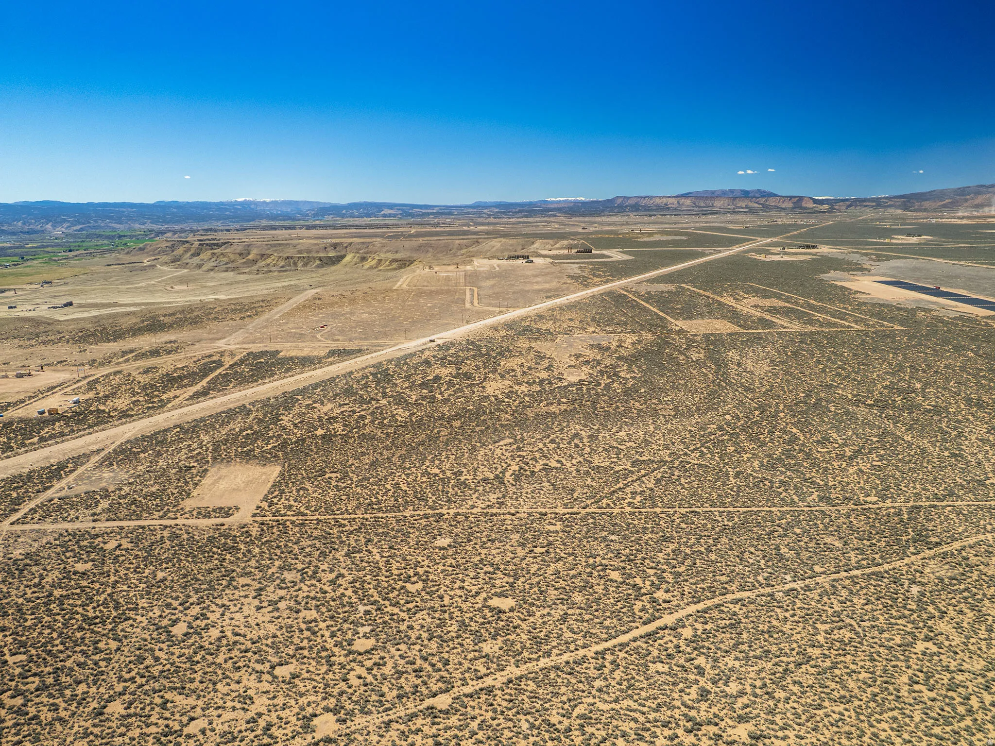 View of rural area featuring mountains and a desert landscape