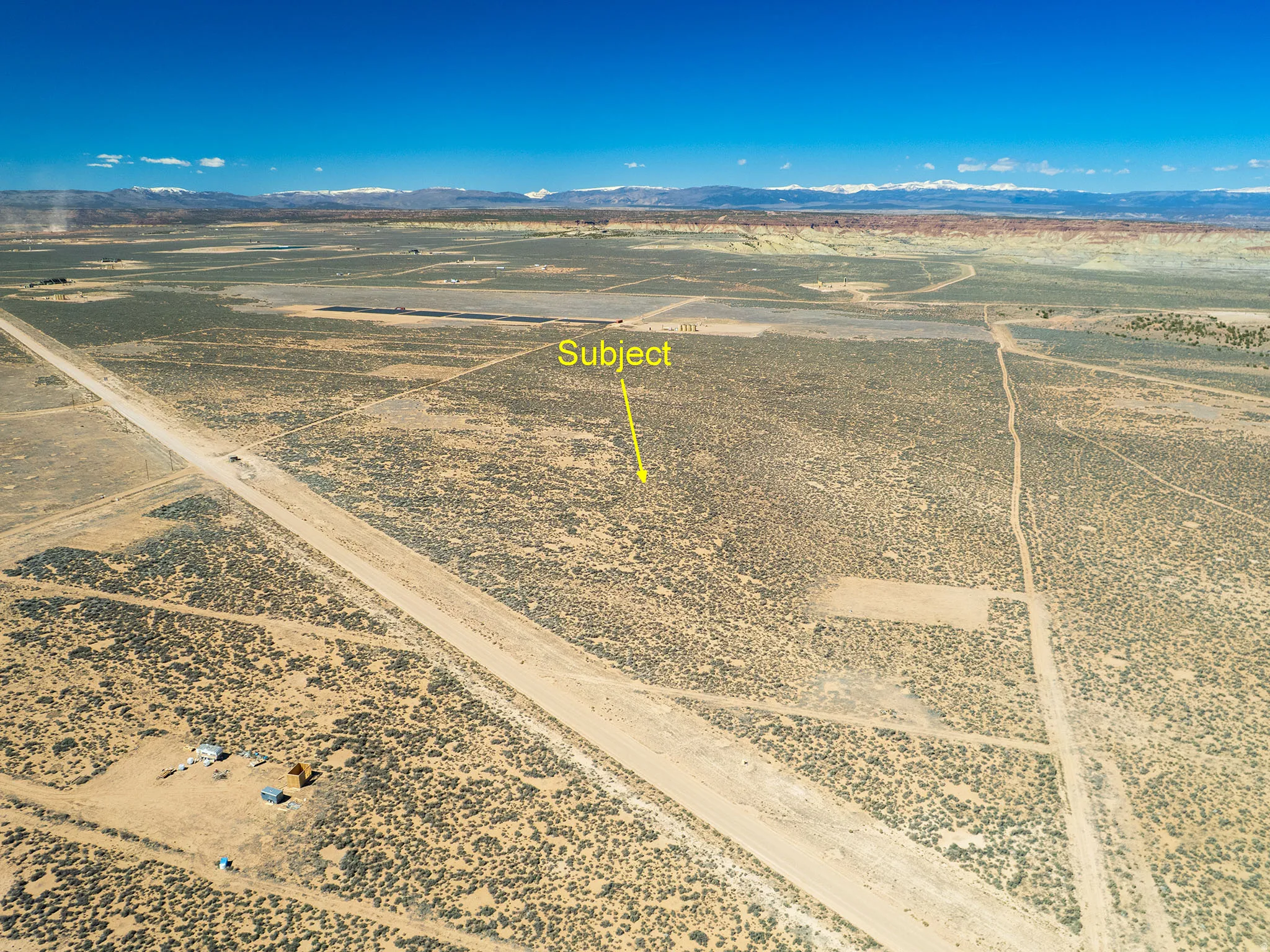 Aerial view of sparsely populated area featuring mountains and a desert landscape