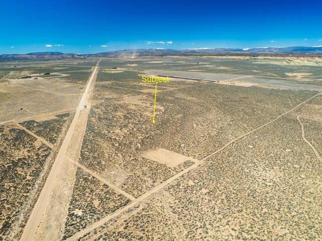 Aerial view of sparsely populated area featuring mountains and a desert landscape