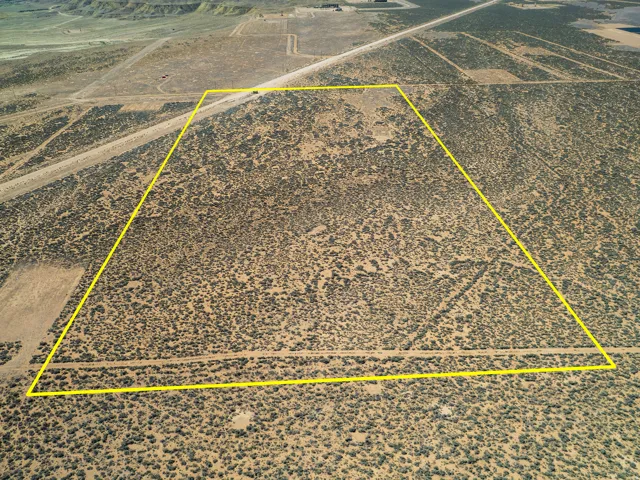 Aerial view of sparsely populated area with a desert landscape and property parcel outlined