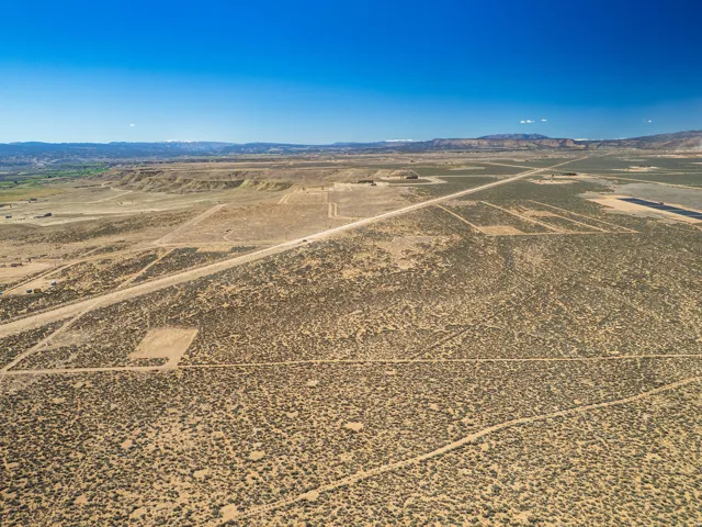 View of rural area featuring mountains and a desert landscape