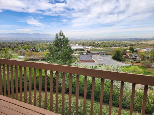 Wooden terrace featuring a mountain view and a residential view